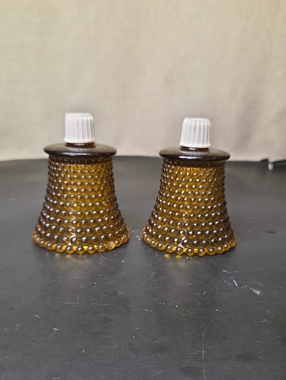2 vintage Home Interior amber glass hobnail peg votive candle holders.